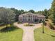 Aerial view of a large brick home with a circular driveway at 320 Riverbend Dr, Mcdonough, GA 30252