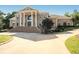 Stately brick home with a grand entrance and a circular driveway at 320 Riverbend Dr, Mcdonough, GA 30252