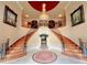 Grand foyer with dual staircase, chandelier, and decorative art at 320 Riverbend Dr, Mcdonough, GA 30252