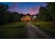 Beautiful brick home surrounded by lush greenery and a long driveway at 320 Riverbend Dr, Mcdonough, GA 30252
