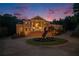 Elegant brick home featuring a grand entrance, mature landscaping, and circular driveway with a horse statue at 320 Riverbend Dr, Mcdonough, GA 30252