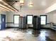 Spacious garage with three windows, cabinets and an open overhead door at 320 Riverbend Dr, Mcdonough, GA 30252