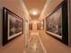 Elegant hallway illuminated by decorative lighting and adorned with framed artwork and tiled flooring at 320 Riverbend Dr, Mcdonough, GA 30252