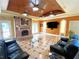 Large living area featuring a fireplace, media center, wood ceiling, and neutral color scheme at 320 Riverbend Dr, Mcdonough, GA 30252