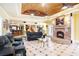 Expansive living room with brick fireplace, bar, and stairs leading to other floors of the residence at 320 Riverbend Dr, Mcdonough, GA 30252