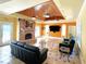 Spacious living room features a brick fireplace, media center, and multiple ceiling fans at 320 Riverbend Dr, Mcdonough, GA 30252