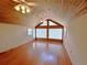 Spacious room with wood paneling, high ceilings, wood-look floors, and large windows at 320 Riverbend Dr, Mcdonough, GA 30252