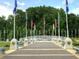 Outdoor memorial honoring veterans with flags and stone monuments in a tranquil park setting at 320 Riverbend Dr, Mcdonough, GA 30252