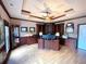 Spacious office with custom wood built-ins, large desk, tray ceiling, and wood-look floors at 320 Riverbend Dr, Mcdonough, GA 30252
