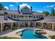 Backyard pool with hot tub, outdoor kitchen, and covered patio seating at 320 Riverbend Dr, Mcdonough, GA 30252