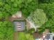 This aerial view shows a home nestled within lush greenery, offering a sense of privacy and tranquility at 64 Edwin Pl Nw, Atlanta, GA 30318