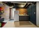 Basement features a sink and cabinets, with a refrigerator and a backdoor at 64 Edwin Pl Nw, Atlanta, GA 30318