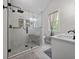 Bathroom features a modern glass shower with a seat, double sinks, and a window at 64 Edwin Pl Nw, Atlanta, GA 30318