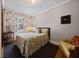 Cozy bedroom with a comfortable bed, wood floors and warm lighting at 64 Edwin Pl Nw, Atlanta, GA 30318