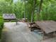 Captured exterior view of a charming home with lush trees, picnic shelter, and expansive driveway at 64 Edwin Pl Nw, Atlanta, GA 30318