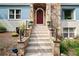 Inviting front entrance with stone accents and a red door, enhanced by landscaping at 64 Edwin Pl Nw, Atlanta, GA 30318