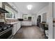 Well-lit kitchen featuring modern appliances, white cabinetry, and stylish backsplash at 64 Edwin Pl Nw, Atlanta, GA 30318