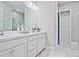 Clean bathroom featuring double sinks, white cabinetry, and a walk-in glass shower at 7220 Winderlea Ln, Cumming, GA 30040