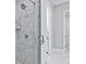 Modern bathroom featuring a spacious shower with marble-style tile and glass door, providing a spa-like experience at 7220 Winderlea Ln, Cumming, GA 30040