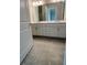 Bathroom features tiled floors, double sinks, and a large mirror, offering a clean aesthetic at 7220 Winderlea Ln, Cumming, GA 30040
