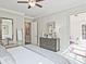 Bright bedroom featuring recessed lights, luxury vinyl plank flooring, and a mirrored dresser at 7220 Winderlea Ln, Cumming, GA 30040