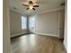 Spacious bedroom with hardwood floors, crown molding, and a glass-paneled door leading outdoors at 7220 Winderlea Ln, Cumming, GA 30040