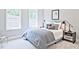 Cozy bedroom featuring natural light, modern decor, and stylish side tables at 7220 Winderlea Ln, Cumming, GA 30040