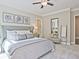 Stylish bedroom with a soft color palette, decorative art, and a cozy seating area at 7220 Winderlea Ln, Cumming, GA 30040