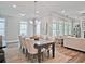 Elegant dining area featuring a large table, comfortable chairs, and ample natural light, perfect for Gathering gatherings at 7220 Winderlea Ln, Cumming, GA 30040