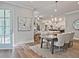 Elegant dining room with hardwood floors and view into open kitchen at 7220 Winderlea Ln, Cumming, GA 30040