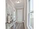 Bright entryway with hardwood floors, a table, and a white front door at 7220 Winderlea Ln, Cumming, GA 30040