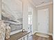 Stylish entryway with hardwood floors, artwork, and a table with vases at 7220 Winderlea Ln, Cumming, GA 30040