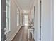 Elegant entryway with hardwood floors, a table, and an open doorway at 7220 Winderlea Ln, Cumming, GA 30040