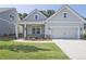 Beautiful home exterior featuring a manicured lawn and two-car garage at 7220 Winderlea Ln, Cumming, GA 30040