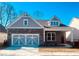 Charming brick home featuring a two-car garage and a welcoming covered porch, perfect for suburban living at 7220 Winderlea Ln, Cumming, GA 30040