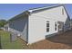 Side view of house with light grey siding and a green grassy area at 7220 Winderlea Ln, Cumming, GA 30040