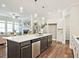Modern kitchen features a large island with stainless steel appliances and pendant lighting at 7220 Winderlea Ln, Cumming, GA 30040