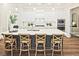 Bright kitchen with a large island, stylish bar stools, and modern white cabinetry, ideal for entertaining at 7220 Winderlea Ln, Cumming, GA 30040