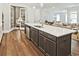 Spacious kitchen island with stainless steel appliances and open concept living area at 7220 Winderlea Ln, Cumming, GA 30040