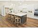 Gourmet kitchen with a large island, pendant lighting, and modern appliances at 7220 Winderlea Ln, Cumming, GA 30040