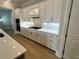 Well-lit kitchen features modern cabinetry, stainless steel appliances, and light hardwood flooring at 7220 Winderlea Ln, Cumming, GA 30040