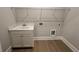 Functional laundry room with a utility sink, storage cabinets, and ample space, making chores easier at 7220 Winderlea Ln, Cumming, GA 30040