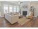 Bright living room with fireplace, large windows, and comfortable seating area at 7220 Winderlea Ln, Cumming, GA 30040