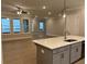 Open-concept living room with hardwood floors and abundant natural light at 7220 Winderlea Ln, Cumming, GA 30040
