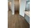Walk-in pantry features hardwood floors and shelving, providing ample storage space at 7220 Winderlea Ln, Cumming, GA 30040