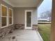 Covered patio featuring brick accents, a door to the house, and view of the yard at 7220 Winderlea Ln, Cumming, GA 30040