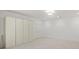 Bright basement featuring neutral carpeting, recessed lighting, ample storage, and access to a separate room at 130 Forrest Aly, Roswell, GA 30075