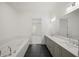 A bathroom featuring a soaking tub, double sinks, shaker cabinets and a walk-in shower at 130 Forrest Aly, Roswell, GA 30075