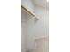 A bright and organized closet with wooden hanging rods and shelves at 130 Forrest Aly, Roswell, GA 30075