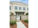 Charming brick townhome with gray shutters, private gated entrance, and manicured landscaping at 130 Forrest Aly, Roswell, GA 30075
